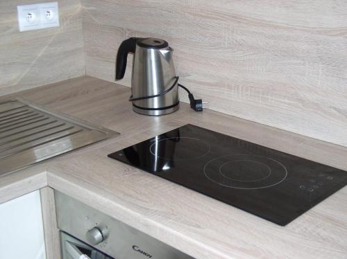 a kitchen counter with a tea kettle on a stove at Apartmán Cyril A 104 in Smokovce