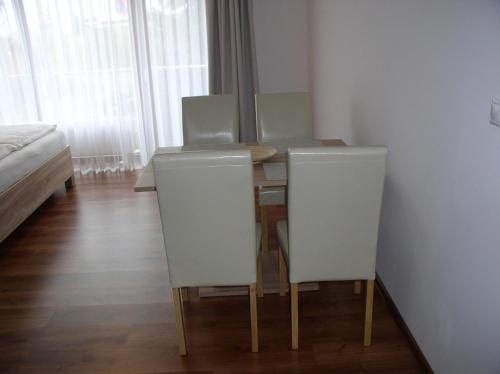 a dining room with a table and two chairs at Apartmán Cyril A 104 in Smokovce