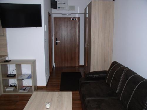 a living room with a couch and a table at Apartmán Cyril A 104 in Smokovce