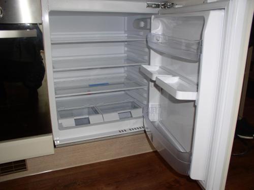 an empty refrigerator with its door open in a kitchen at Apartmán Cyril A 104 in Smokovce