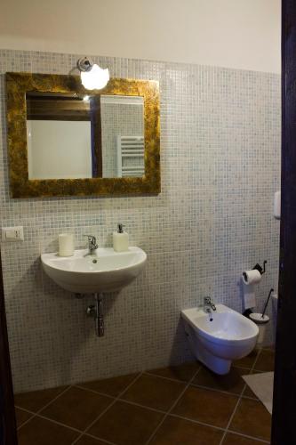 a bathroom with a sink and a toilet at B&B Charme Sa Pardina in Orroli