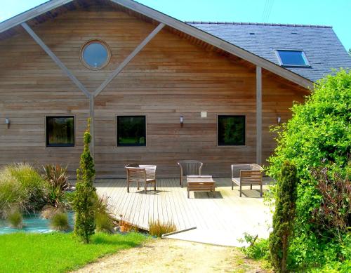 a house with a table and chairs in front of it at Chambres d'Hôtes Le Nid d'Iroise in Lanildut