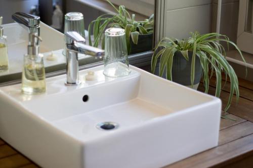 a white sink in a bathroom with a mirror at Les Chambres d'Hôtes du Grand Mornas in Carry-le-Rouet