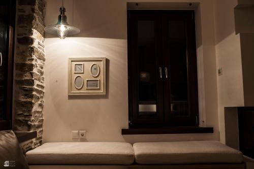 a living room with a couch and a window at Stone Villa Pelion in Afissos