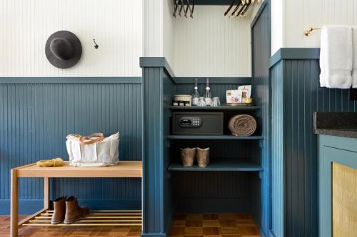 a blue room with a small table and a shelf at Anvil Hotel in Jackson