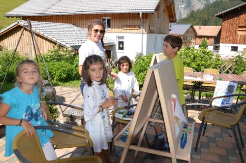 a group of children standing next to a man at Villa Natur in Schröcken