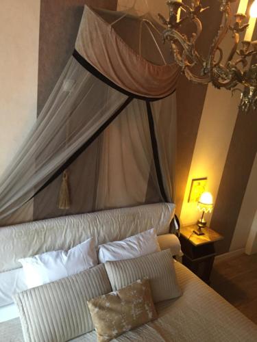 a bedroom with a bed with a canopy at B&B Con Ampère in Bruges