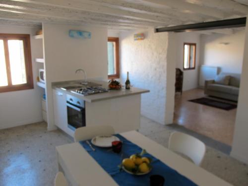 a kitchen and living room with a table with bananas on it at Arsenale Venice for Insider in Venice