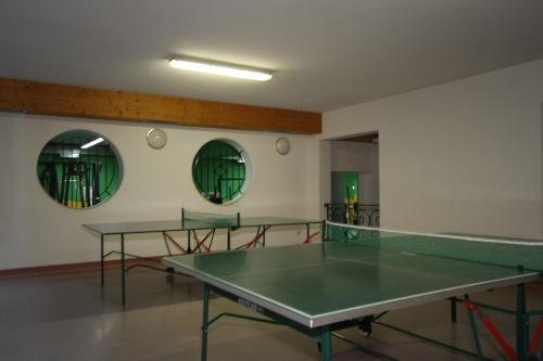 a room with two ping pong tables and two mirrors at Hotel Lohninger-Schober 3 Stern Superior in Sankt Georgen im Attergau