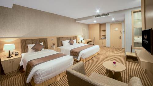 Un pat sau paturi într-o cameră la Muong Thanh Luxury Vientiane Hotel