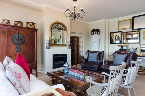 
a living room filled with furniture and a fireplace at Whale View Manor Guesthouse & Spa in Simonʼs Town
