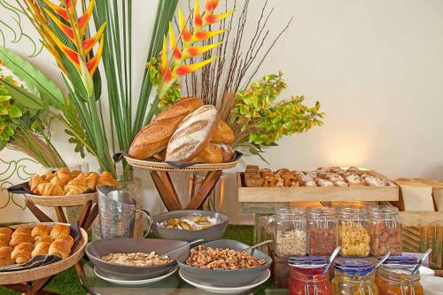 a table topped with lots of different types of bread at Plantation Urban Resort & Spa in Phnom Penh