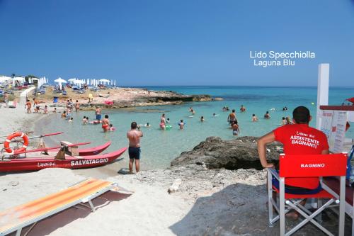 a group of people in the water at a beach at Villa Victory in Specchiolla 