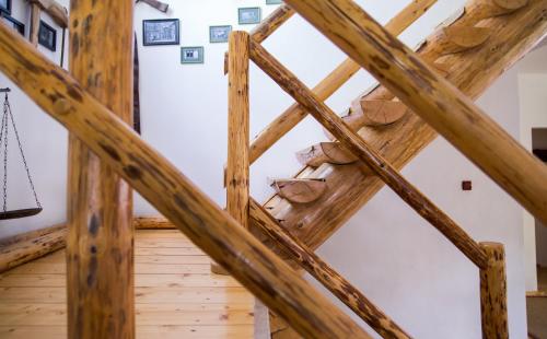a view from the loft of a wooden building with beams at Casa Mosului - Transfăgărășan Bed & Breakfast in Cîrţişoara