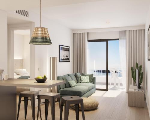 a living room filled with furniture and a table at Sunrise Suites in Ibiza Town