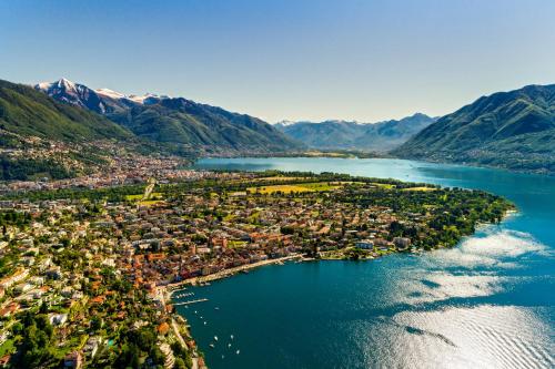 an aerial view of a town on a lake with mountains at Casa Berno Panorama Resort in Ascona