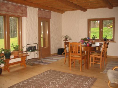 a living room with a wooden table and chairs at Kõrgemäe puhketalu in Eoste