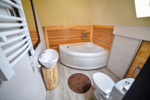 a bathroom with a tub and a toilet and a sink at Vila Breg Zlatibor in Zlatibor