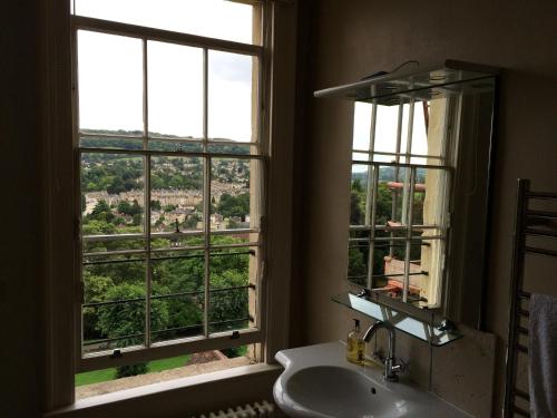 a bathroom with a sink and a window with a view at No 4 Ainslie's Belvedere B&B in Bath