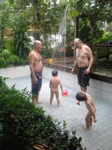 a group of men standing in a swimming pool at Flower and Green Collection in Shunan