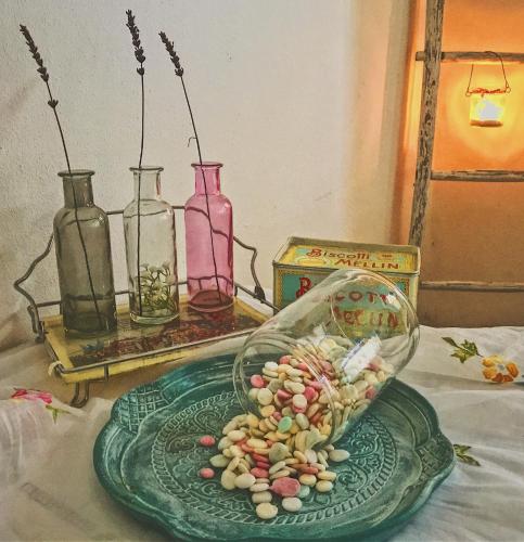 a plate of food on a table with vases at Le Tartarughe rooms in Magliano in Toscana