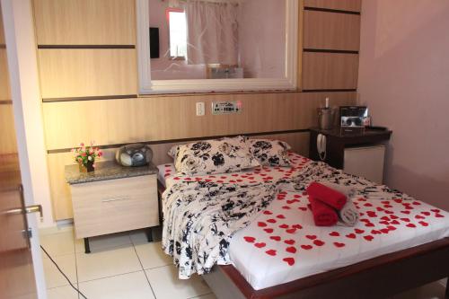 a bedroom with a bed with red hearts on it at Motel Paradise (Adults only) in São José dos Campos