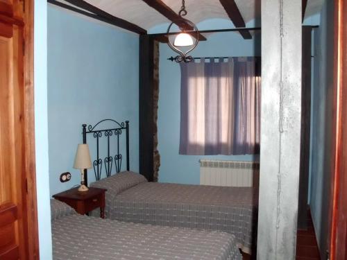 - 2 lits jumeaux dans une chambre aux murs bleus dans l'établissement Tia Rulla 1, à Pina de Montolgrao