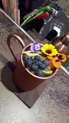 a cup filled with fruit and flowers on a counter at Hotel Ricci in Rimini