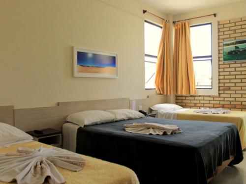 Кровать или кровати в номере Silvestre Praia Hotel