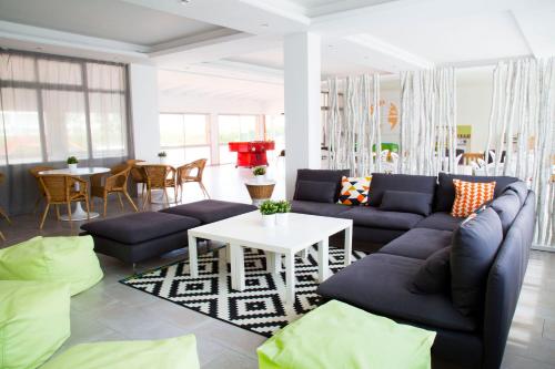 a living room with blue couches and a white table at RVApartaments Estartit Confort in L'Estartit