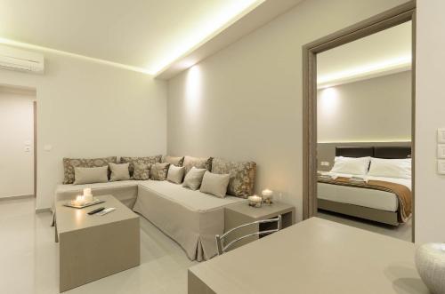 a living room with a couch and a bed at Vice Hotel in Laganas