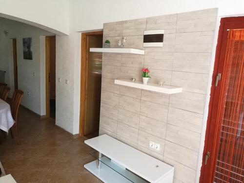 a room with a bench and shelves on a wall at Apartments Ema Vir in Vir