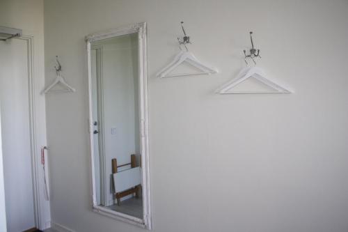 a mirror in a room with a chair and lights at Wramsta B&B in Tollarp