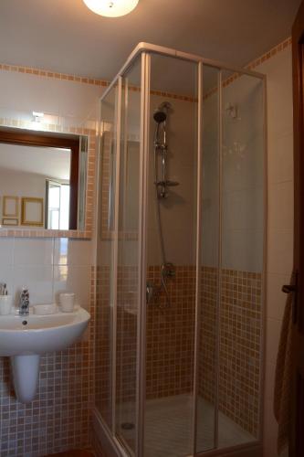 a bathroom with a shower and a sink at Maison Huguette in Civitavecchia