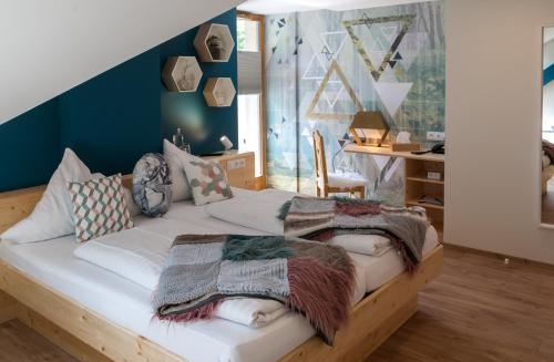 a bedroom with a bed with pillows on it at Hostellerie Les Bagenelles in Sainte-Marie-aux-Mines