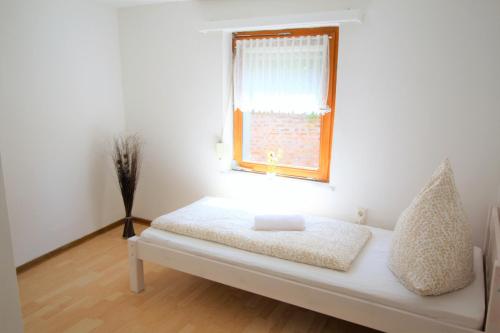 a bedroom with a bed with a window and a pillow at Work & Stay in Zuelpich in Zülpich