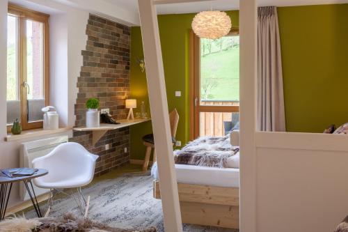 a bedroom with green walls and a bed and a window at Hostellerie Les Bagenelles in Sainte-Marie-aux-Mines
