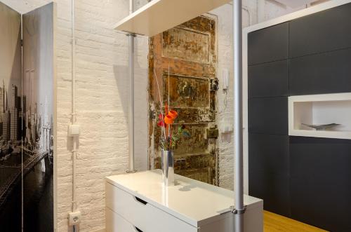 a room with a vase with a red rose in it at Loft en Gràcia ArchsenseApartments in Barcelona
