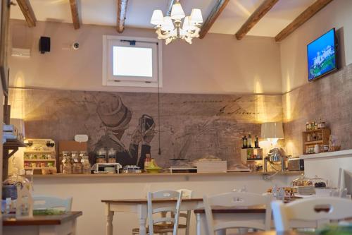 a restaurant with a table and chairs in a room at Cas'E Charming House in Caserta