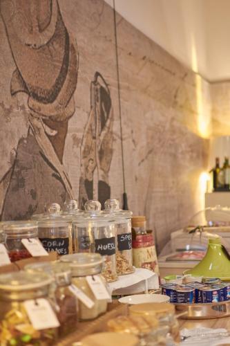 a table with jars of food on top of it at Cas'E Charming House in Caserta