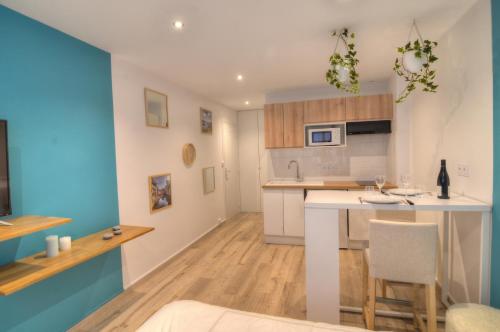 a kitchen with white cabinets and a counter top at Les Quais d'Annecy in Annecy