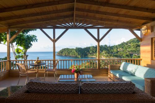 a living room with a view of the ocean at Castara Retreats in Castara