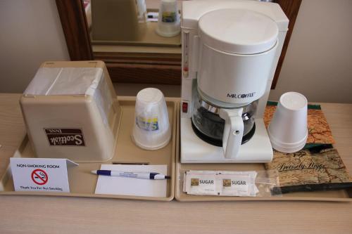 a coffee maker sitting on a table next to a box at Scottish Inns Sparta in Sparta