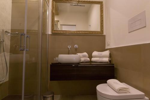 a bathroom with a sink and a shower and a toilet at Liberty Palace in Milazzo