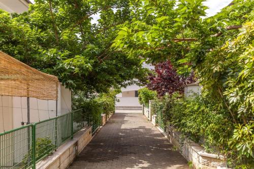 an alley way with trees and a fence at Villa Victory in Specchiolla 