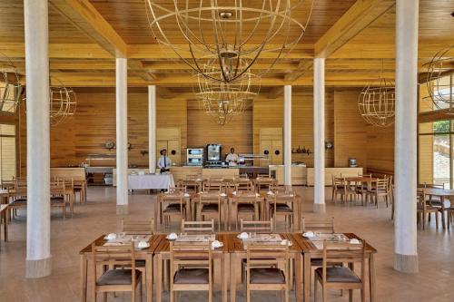 a dining room with tables and chairs in a building at Hotel Dakhla Club & SPA in Dakhla