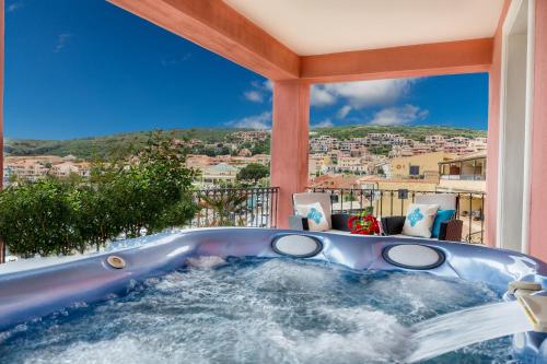 a jacuzzi tub on a balcony with a view at La Vecchia Fonte Boutique Hotel in Palau