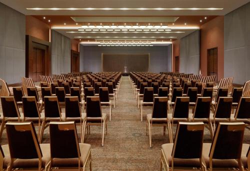 an empty conference room with chairs and a screen at Radisson Blu Hotel, Conakry in Conakry