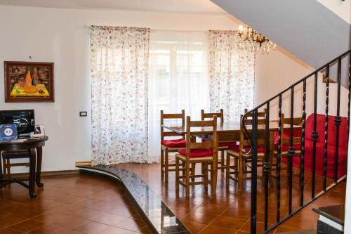 a dining room and kitchen with a table and chairs at La Quiete in Anagni