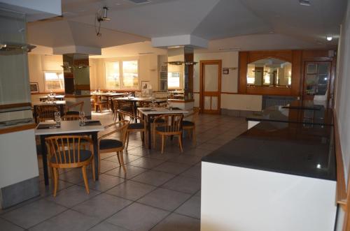 a restaurant with tables and chairs in a room at Hotel Brujas De Irues in Tarazona de Aragón